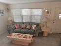 Cozy living room with a large window that offers plenty of natural light and a comfortable seating area at 650 Pinellas Point S Dr # 101, St Petersburg, FL 33705