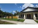 Well-maintained home with a tidy lawn, fresh plantings, and a newly stained fence at 7013 N 15Th St, Tampa, FL 33610