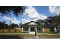 Inviting single-story home with lush green lawn, fresh landscaping and wood fence at 7013 N 15Th St, Tampa, FL 33610