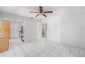 Bright dining room with white tile floor, ceiling fan and view of the kitchen at 7125 14Th S Ave, South Pasadena, FL 33707