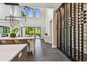 Bright, airy living space with floor-to-ceiling windows, a modern wine rack, and sleek finishes at 715 W Peninsular St, Tampa, FL 33603