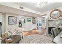 Open-concept living room features a stylish fireplace, wood floors, and seamless access to kitchen and outdoor patio at 4222 Hartwood Ln # 1202, Tampa, FL 33618