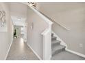 Bright hallway with tile flooring, a staircase, and views into the dining area offering an open layout at 10142 Golden Wonder Ln, Riverview, FL 33578