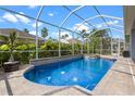 Sparkling screened-in pool and spa with brick surround, perfect for relaxation and entertainment at 10502 Brentford Dr, Tampa, FL 33626