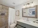 Bathroom featuring a shower with tile surround, updated vanity and modern fixtures at 106 W Louisiana Ave, Tampa, FL 33603