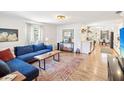 Cozy living room with hardwood floors, a blue sofa, and an inviting layout at 106 W Louisiana Ave, Tampa, FL 33603