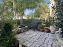 Serene backyard patio featuring a stone surface, lush landscaping, and a cozy seating area at 10953 Winter Crest Dr, Riverview, FL 33569