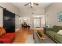 Spacious living room with hardwood floors, ceiling fan, high ceilings, and a rustic sliding barn door at 1308 Peachfield Dr, Valrico, FL 33596