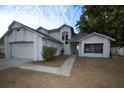 A two-story home with a two-car garage, neutral exterior paint and landscaping at 13218 Parkhurst Ct, Riverview, FL 33569
