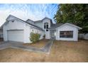 A two-story home with a two-car garage, neutral exterior paint and landscaping at 13218 Parkhurst Ct, Riverview, FL 33569