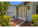 Charming home entrance featuring a decorative door, accent plants, and a welcoming ambiance at 1416 Leland Dr # 49, Sun City Center, FL 33573