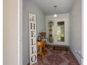 Welcoming foyer area with a decorative table, carpet and decorative art pieces providing a pleasant entry at 1416 Leland Dr # 49, Sun City Center, FL 33573
