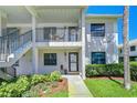 Two-story condo building with well-maintained landscaping, exterior stairs, and covered balconies at 2139 Elm St # 308, Dunedin, FL 34698