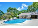 Community pool with ample seating and well-maintained pool house, perfect for relaxation and recreation at 2139 Elm St # 308, Dunedin, FL 34698