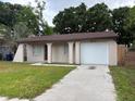 Front exterior showcasing a charming single story home, lawn, and driveway at 2713 W Chestnut St, Tampa, FL 33607