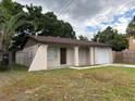 Exterior shot of a single Gathering home with a concrete driveway and fenced in yard at 2713 W Chestnut St, Tampa, FL 33607