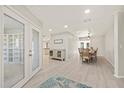 View from the front of the home into dining room with modern lighting and neutral design tones at 2886 Green Meadow Ct, Clearwater, FL 33761
