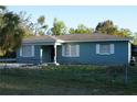 Quaint home featuring fenced yard and well-lit windows at 3421 E Powhatan Ave, Tampa, FL 33610