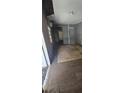 Distressed living room space featuring damaged walls, and worn flooring at 4207 E Henry Ave, Tampa, FL 33610
