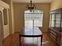 Traditional dining room with hardwood floors, large window and classic chandelier at 5401 Locklear Pl, Riverview, FL 33578