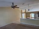 Bright living room featuring neutral carpet, ceiling fan and open floor plan at 5401 Locklear Pl, Riverview, FL 33578