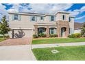 Two-story home showcases blue shutters, light gray siding, a stone accented entrance and manicured lawn at 5416 Camberwell Ln, Riverview, FL 33578