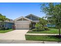 Charming single-story home with a two-car garage, well-kept lawn, and beautiful landscaping at 5547 Silver Sun Dr, Apollo Beach, FL 33572