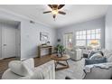 Cozy living room featuring a ceiling fan, hardwood floors, modern furniture, and a bright window at 800 S Dakota Ave # 241, Tampa, FL 33606