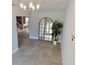 Inviting foyer with tile flooring, a decorative mirror, and views into other living spaces at 8025 Island Dr, Port Richey, FL 34668
