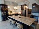 Modern kitchen with a large island, marble countertops, stainless steel appliances, and pendant lighting at 8025 Island Dr, Port Richey, FL 34668