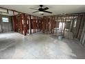 Open-concept living room featuring tiled flooring and exposed wooden framing; ceiling fan included at 844 Bruce Ave, Clearwater Beach, FL 33767