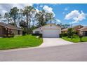 Single story home with a well manicured front lawn at 9500 Green Needle Dr, New Port Richey, FL 34655