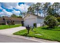 Single story house with green lawn and an attached two-car garage at 9500 Green Needle Dr, New Port Richey, FL 34655