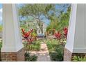 Inviting exterior shot of a home showcasing lush landscaping and a brick walkway at 1014 7Th Street N, St Petersburg, FL 33701