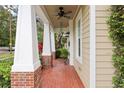 Covered porch featuring brick columns, a ceiling fan, and a brick floor at 1014 7Th Street N, St Petersburg, FL 33701