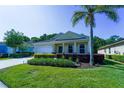 Charming single-story home featuring a well-manicured lawn, landscaping, and a two-car garage at 11252 Merganser Way, New Port Richey, FL 34654