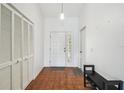 Tiled entryway featuring a coat closet for storage at 13003 Titleist Dr, Hudson, FL 34669