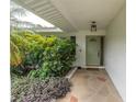 Inviting front porch with decorative stone flooring and lush greenery, creates a welcoming entrance at 1313 Markley Dr, Largo, FL 33770