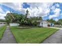 Well-manicured front yard with lush landscaping and healthy green grass surrounding a well maintained home at 1313 Markley Dr, Largo, FL 33770