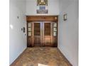 Elegant entrance with wooden double doors, brick flooring, and 'North Tower' sign at 1325 Snell Isle Ne Blvd # 505, St Petersburg, FL 33704