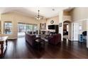 Spacious living room features vaulted ceiling, wood floors, fireplace, and sliding door access to the pool at 14042 Marlberry Way, Odessa, FL 33556