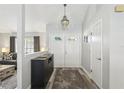 Bright entryway featuring stylish decor, a statement chandelier, a decorative table, and wood-look flooring at 1421 Buckner Rd, Valrico, FL 33596