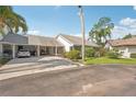 Charming home with a covered carport and a well-manicured lawn at 1613 Comfy Ct, Sun City Center, FL 33573