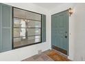 Inviting front door with a window and tile flooring at 1613 Comfy Ct, Sun City Center, FL 33573