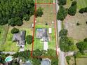 Aerial view of the property showcasing the expansive lot, pool area, and surrounding landscape at 16220 Lake Armistead Way, Odessa, FL 33556