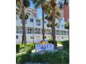 Well-maintained condos in Sunset Reef with lush landscaping and a community sign at 17960 Gulf Blvd # 101, Redington Shores, FL 33708