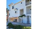 Beautiful exterior with a covered parking area and a view of the unit's entrance and manicured landscaping at 17960 Gulf Blvd # 101, Redington Shores, FL 33708