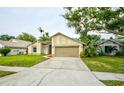 Lovely single-Gathering home with a spacious driveway, attached two-car garage, and vibrant green lawn at 1955 Cobblestone Way, Clearwater, FL 33760