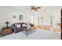Cozy living room featuring a ceiling fan and views of the front entry at 1972 Wolf Laurel Dr, Sun City Center, FL 33573