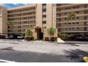Close up on building entrance with covered parking and manicured landscaping at 2617 Cove Cay Dr # 206, Clearwater, FL 33760